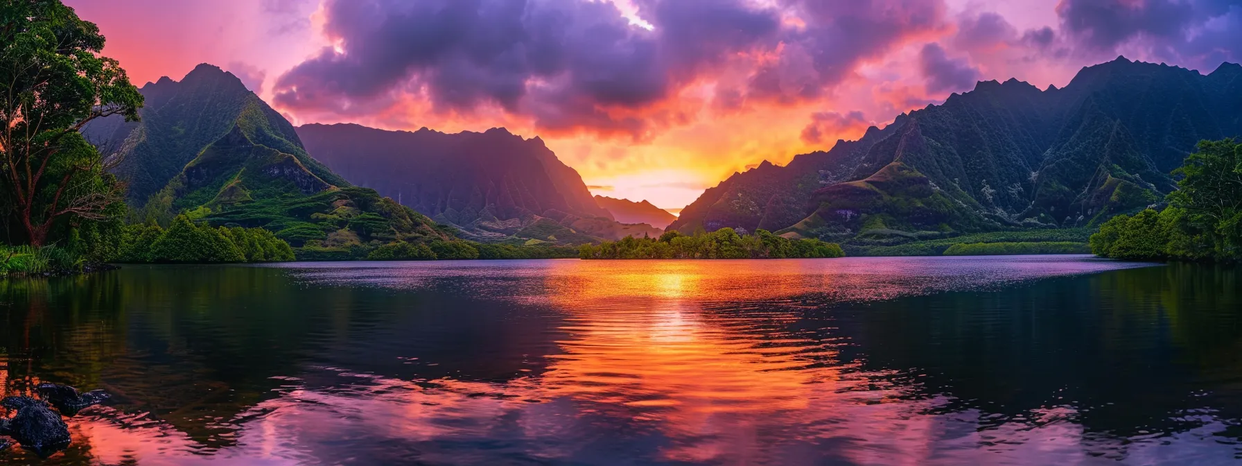 Sunset over lake with mountains, orange and purple reflections