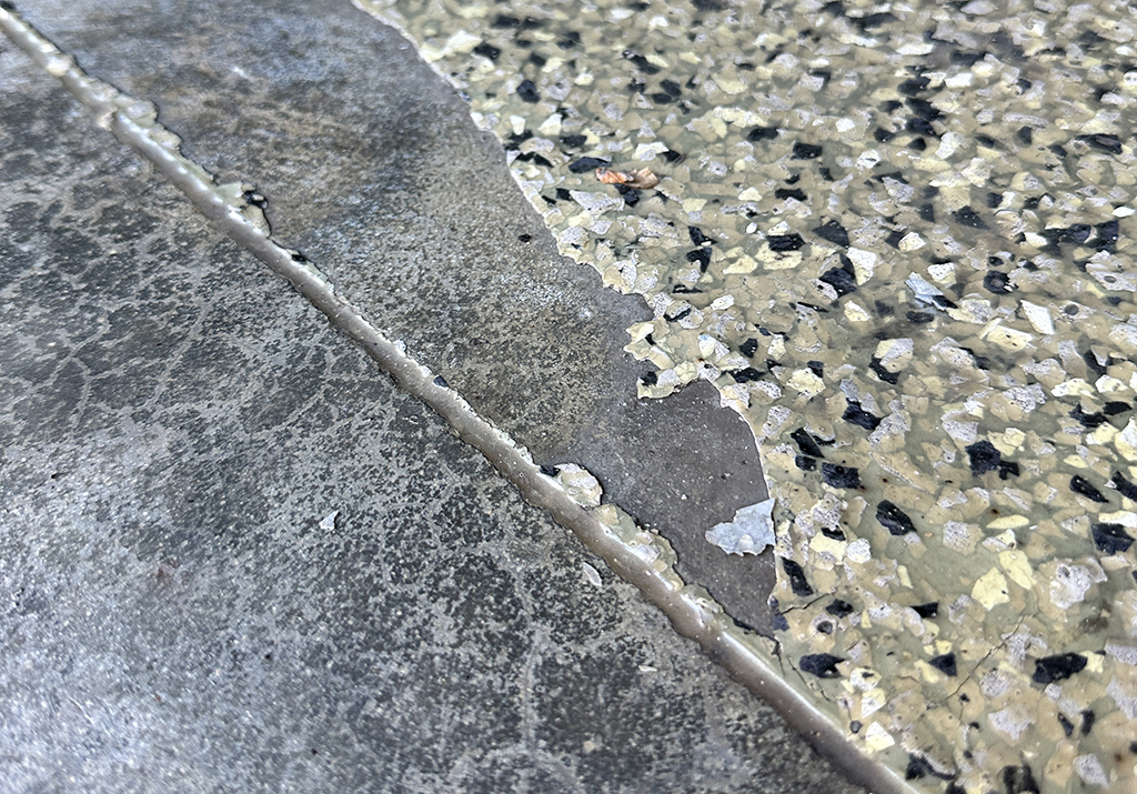 a close up of a crack in a concrete floor