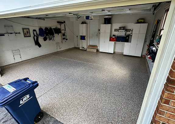 man grinding garage concrete