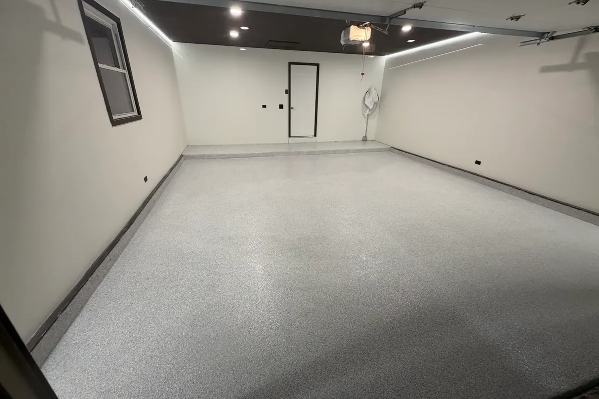 Completed polyurea flake garage floor with a coated wall base and slip-resistant topcoat in Palatine, IL
