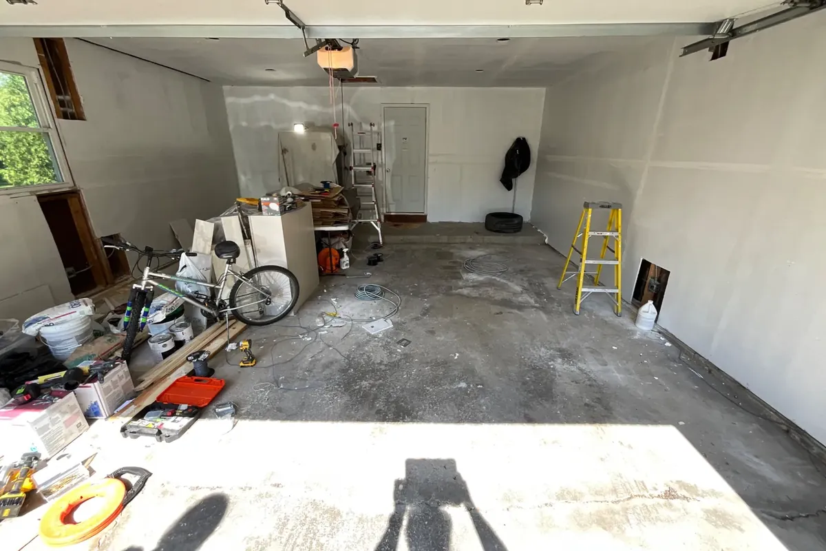 Older uncoated concrete garage floor with stains and surface wear in Palatine, IL before the polyurea coating
