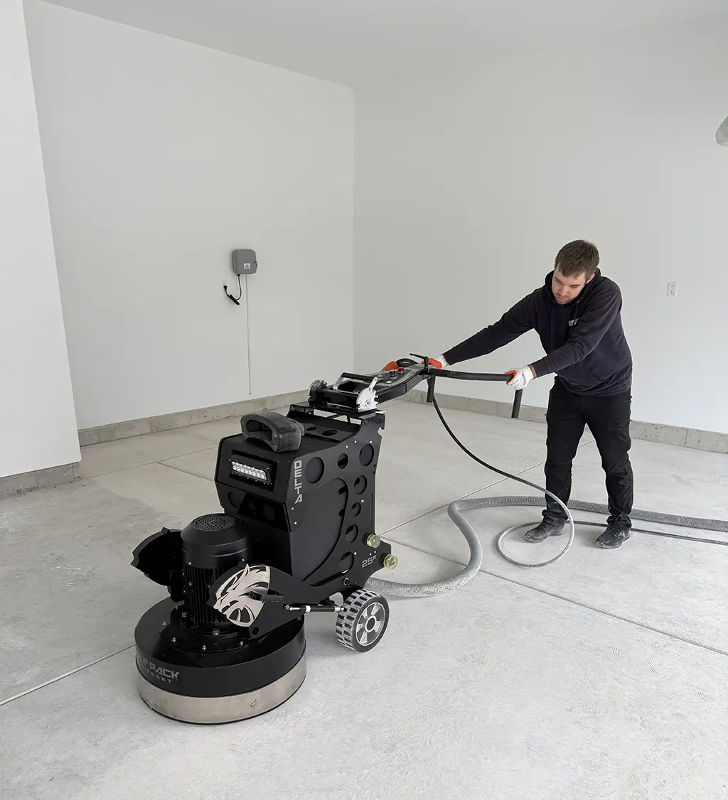 man grinding garage concrete floor