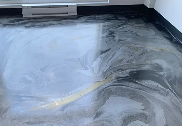 Metallic epoxy basement floor with decorative swirl