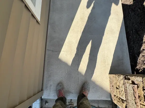 Side walkway concrete with hairline cracks before prep and coating
