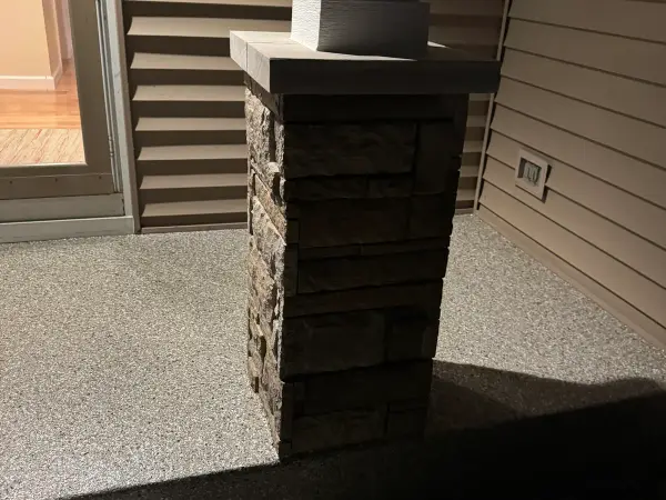 Finished porch with polyurea flake coating around a stone column