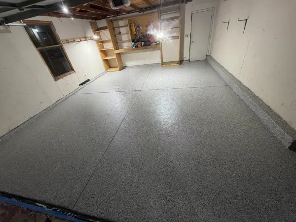 Completed polyurea flake garage floor in Arlington Heights with cove edges