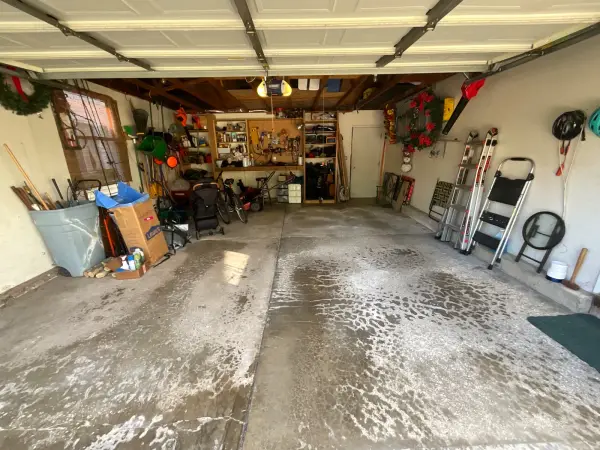 Garage floor before coating with worn, flaking concrete surface in Arlington Heights