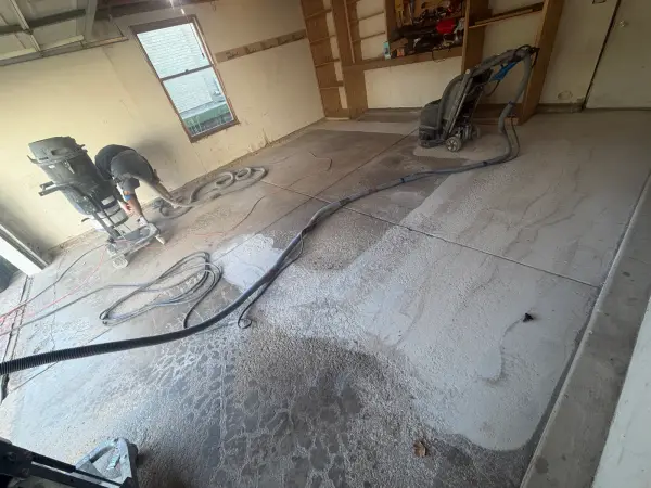 Diamond grinding the garage floor to remove old surface and open concrete