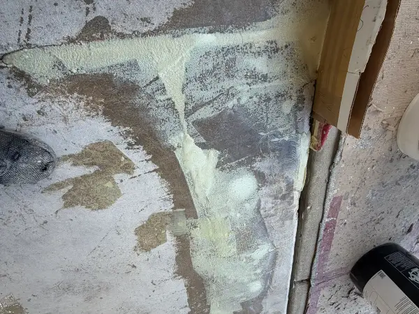 Cracks along floor edge filled with repair material after grinding