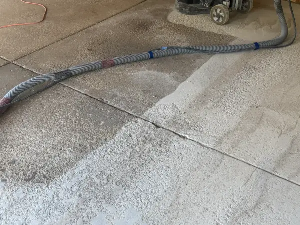 Ground and unground concrete side by side showing joint and surface prep