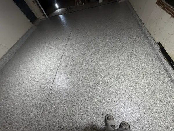 Finished polyurea garage floor with Tidal Wave flake and glossy sheen