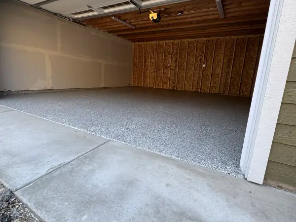 Finished garage floor with gray polyurea flake coating in Arlington Heights, IL