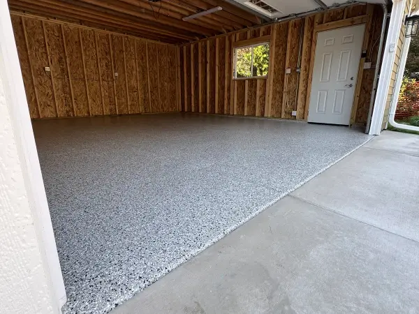 Completed Cabin Fever flake polyurea garage floor with glossy finish