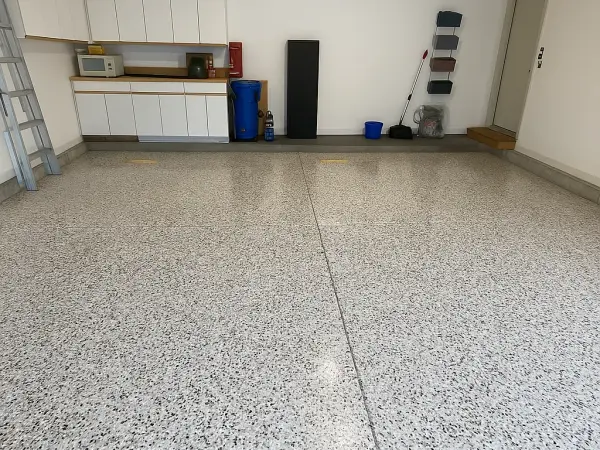 Finished garage floor with light gray and black flake coating and gloss