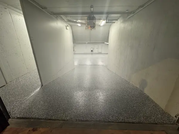 Glossy Nightfall flake polyurea coating on garage entrance and ramp floor