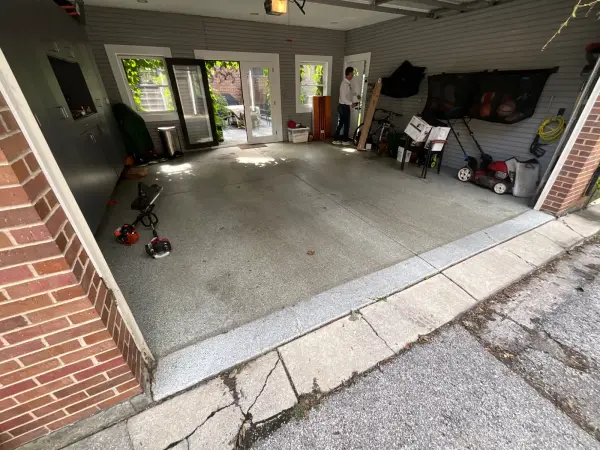 Garage floor before coating, with worn old speckled finish and stains