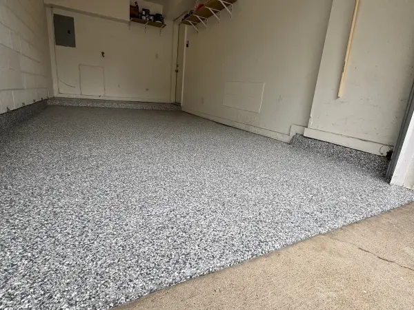Close view of gray gravel flake polyurea coating on the garage floor
