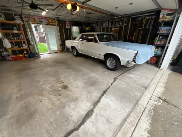 Garage floor before coating with long crack and oil stains in Chicago