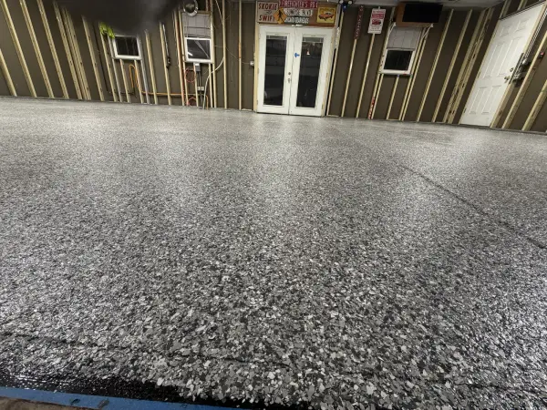 Low angle view of glossy gravel flake texture on finished garage floor