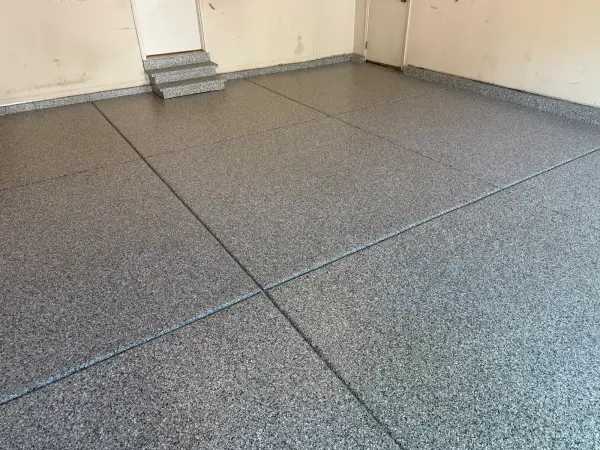 Gravel blend flake coating on garage floor, steps and wall cove base