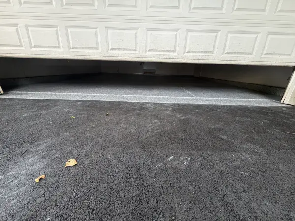 New gravel flake garage floor seen under a partly open door