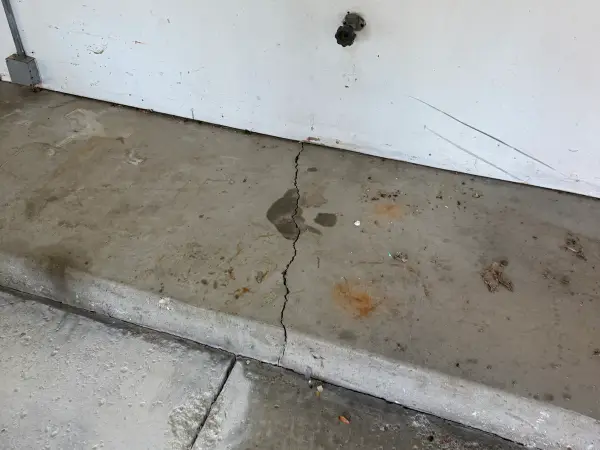 Cracked and stained garage step before coating, Hawthorn Woods, IL