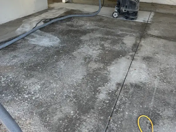 Diamond grinding the stained garage floor to open the concrete