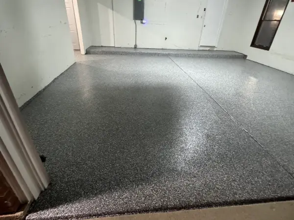 Finished garage floor and step in gray flake polyurea, high gloss