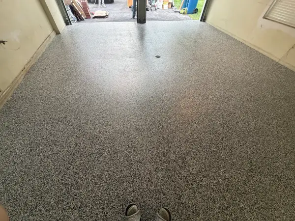 Finished polyurea garage floor with Domino flake blend and satin sheen