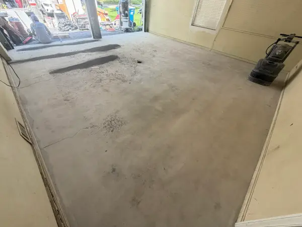 Garage floor ground smooth with cracks patched, ready for base coat