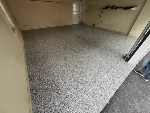 Full black and white Domino flake coating across the finished garage floor
