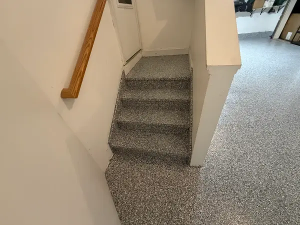 Garage steps and landing finished in gray gravel flake polyurea coating