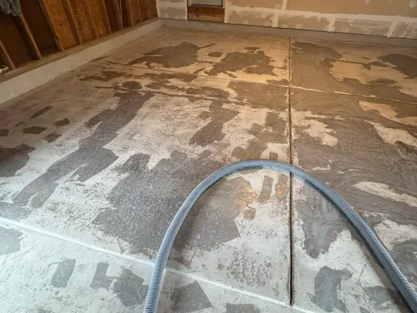 Garage floor during grinding prep with old coating partly removed