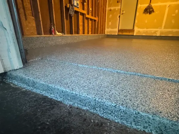 Finished Nightfall polyurea flake garage floor with coated front edge